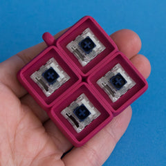 Plum four slot keycap clicker base with switches front view.