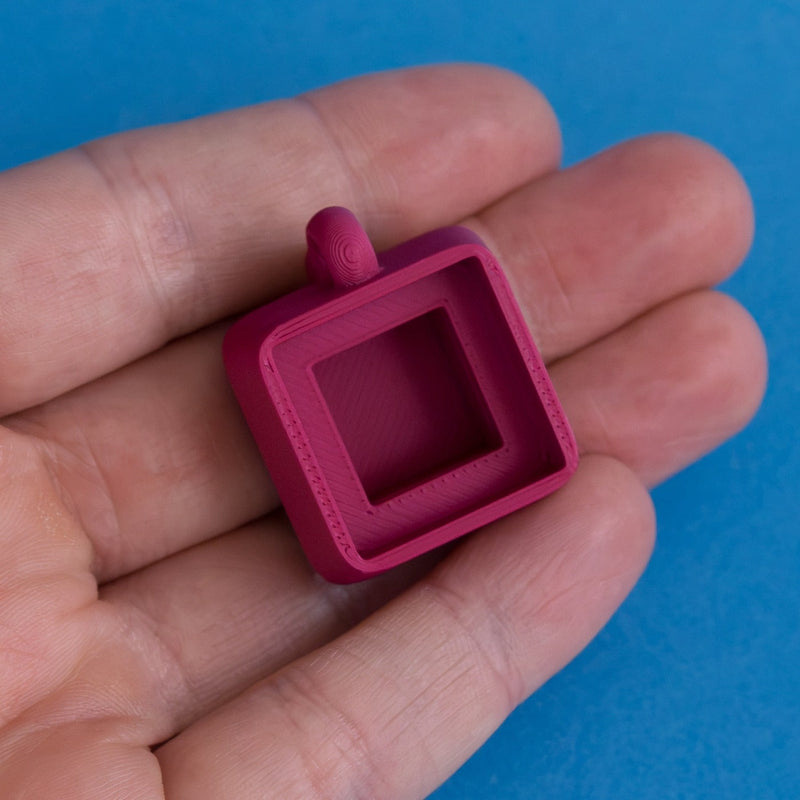 Plum keycap clicker base empty in hand front view.