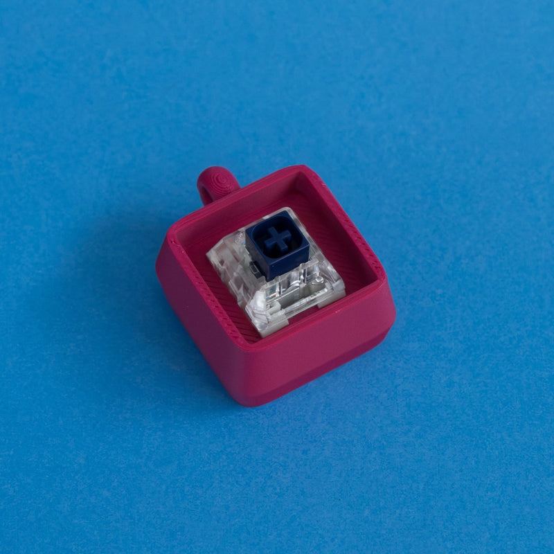 Plum keycap clicker base with switch three quarter view.
