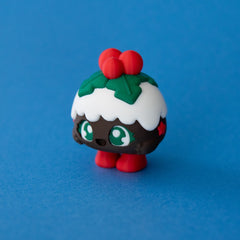 Plum the Christmas Pudding Clicker front view on a blue background