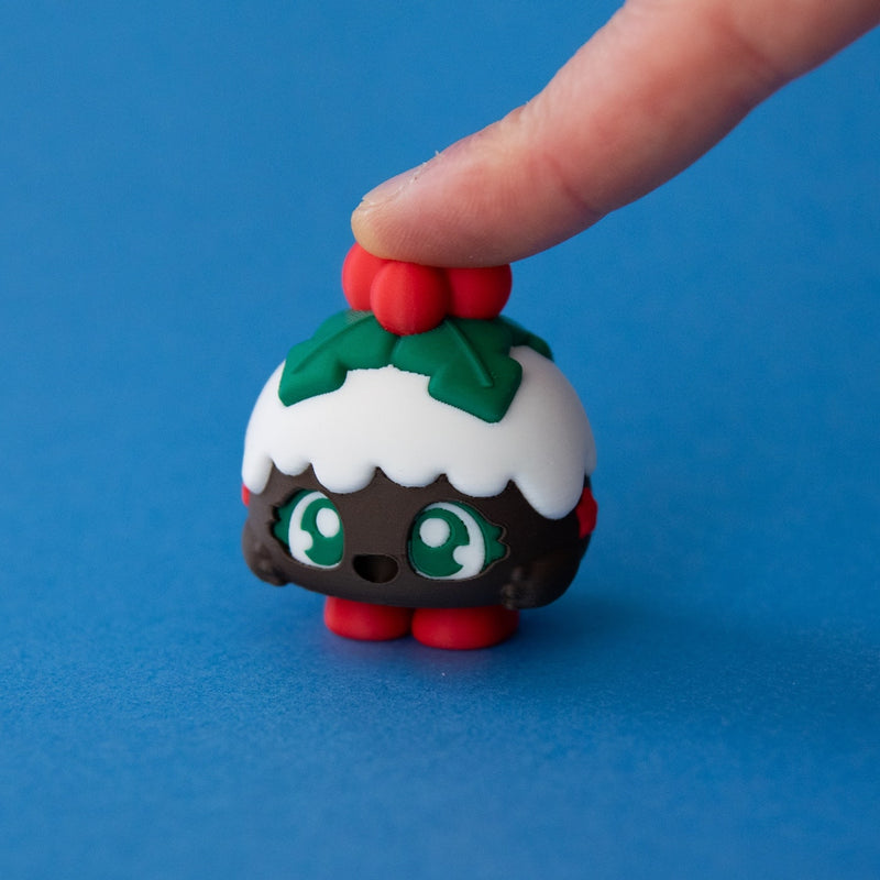 Plum the Christmas Pudding Clicker pressed on a blue background