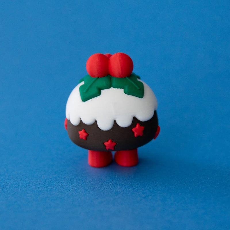 Plum the Christmas Pudding Clicker rear view on a blue background