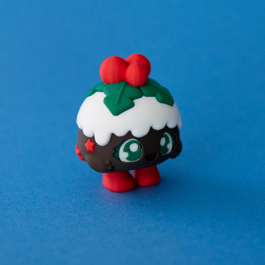 Plum the Christmas Pudding Clicker three quarter view on a blue background