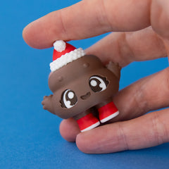 Poopie the Christmas Clicker in hand pressed on a blue background