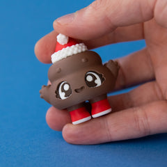Poopie the Christmas Clicker in hand released on a blue background