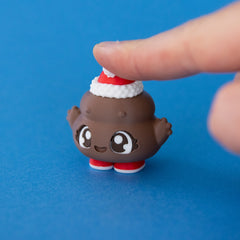 Poopie the Christmas Clicker pressed on a blue background
