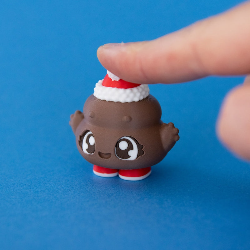 Poopie the Christmas Clicker pressed on a blue background