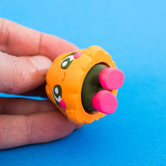 Underside of Posie showing pink pop-up feet and stem mechanism.