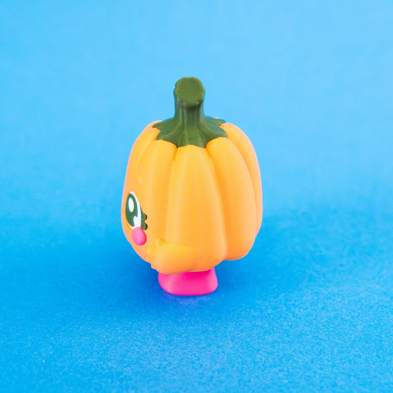 Side profile of Posie showing the pumpkin body, stem and feet.