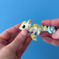 Blossom the Spring Dragon 3D printed fidget wiggling in hand