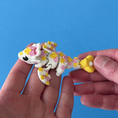 Blossom the Spring Dragon 3D printed fidget wiggling in hand