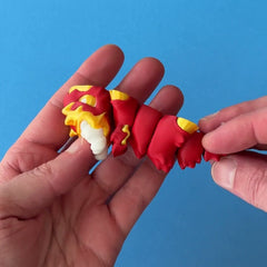 Bram the Aries Dragon 3D printed fidget wiggling in hand