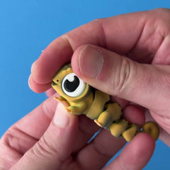 Camellia the Colour-Shift Chameleon 3D printed fidget wiggling in hand