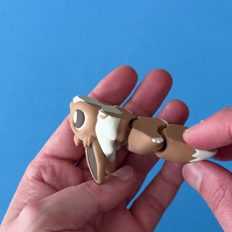 Evonk the Fanchonk Dragon 3D printed fidget wiggling in hand