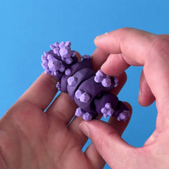 Gemble the Amethyst Dragon 3D printed fidget wiggling in hand