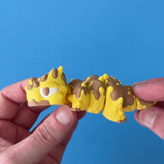 Gloop the Honey Dragon 3D printed fidget wiggling in hand