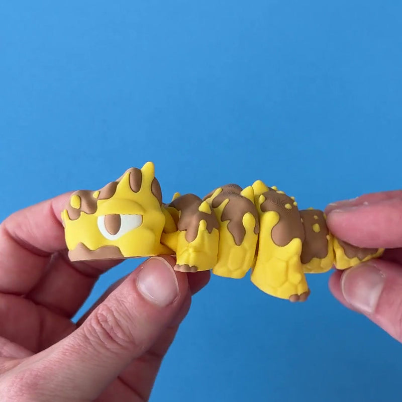 Gloop the Honey Dragon 3D printed fidget wiggling in hand