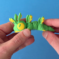Nibs the Bug Chonk Dragon 3D printed fidget wiggling in hand