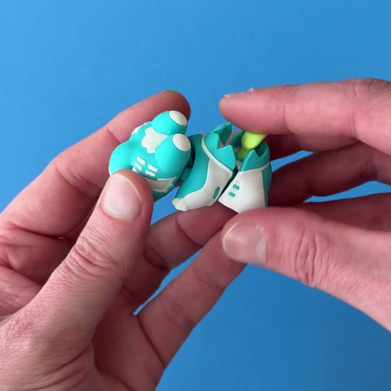 Noot the Hydroponic Babychonk 3D printed fidget wiggling in hand