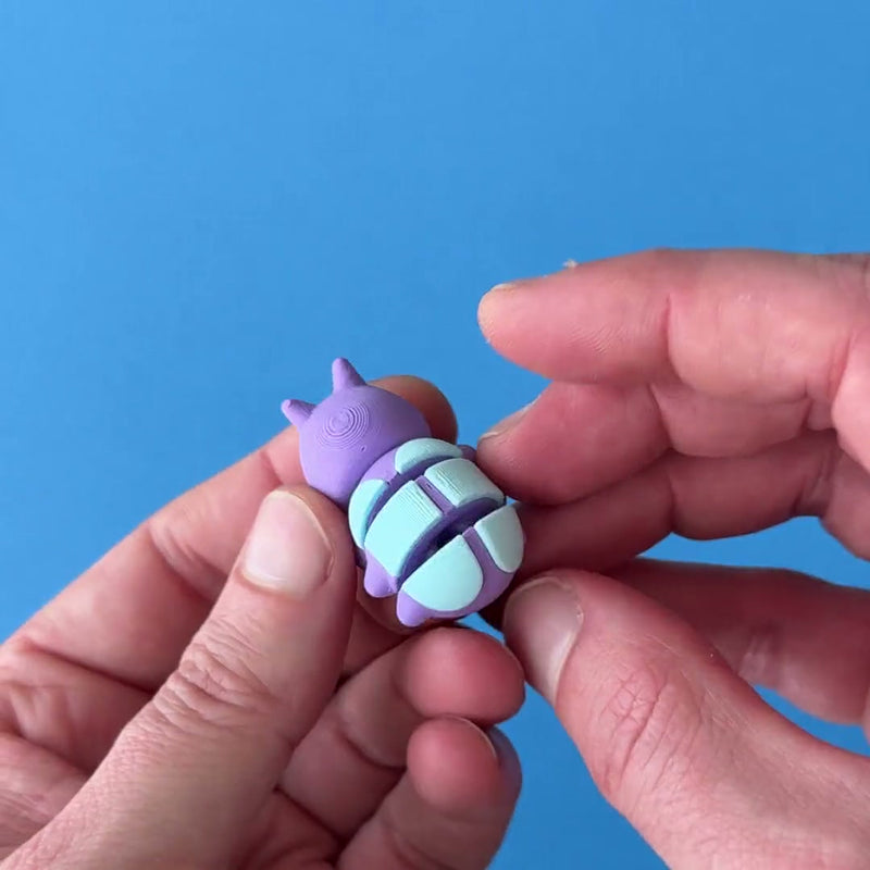 Pebble the Pill Bug 3D printed fidget wiggling in hand