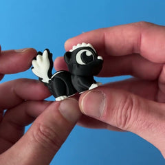 Pepper the Skunk 3D printed fidget wiggling in hand