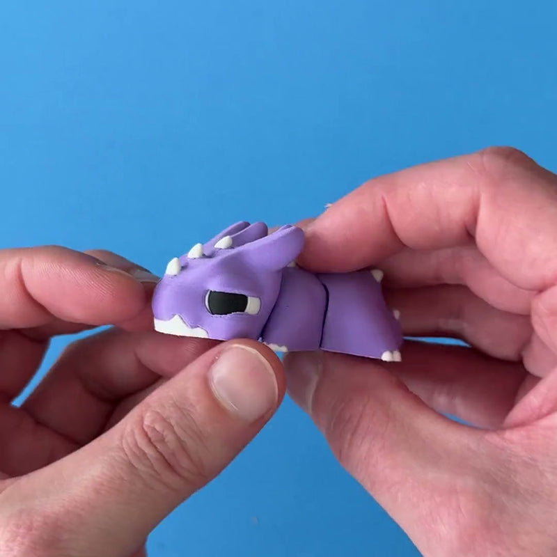 Prickl the Spiky Chonk Dragon 3D printed fidget wiggling in hand