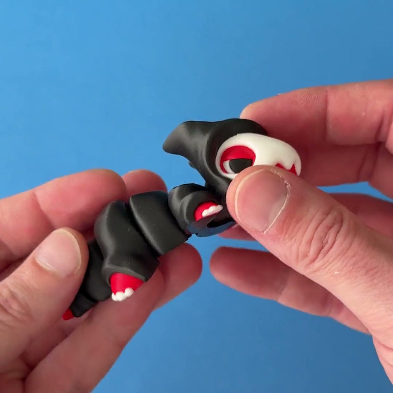 Reapo the Reaper Chonk Dragon 3D printed fidget wiggling in hand