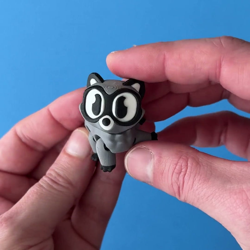 Rilo the Raccoon 3D printed fidget wiggling in hand
