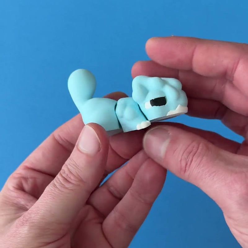 Ripple the Chonk Dragon 3D printed fidget wiggling in hand