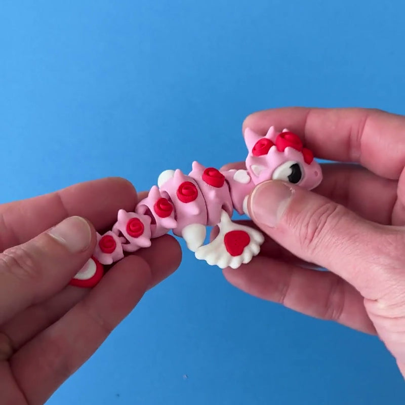 Cupid the Love Dragon 3D printed fidget wiggling in hand