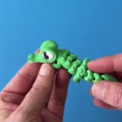 Snappo the Croc Hatchling 3D printed fidget wiggling in hand