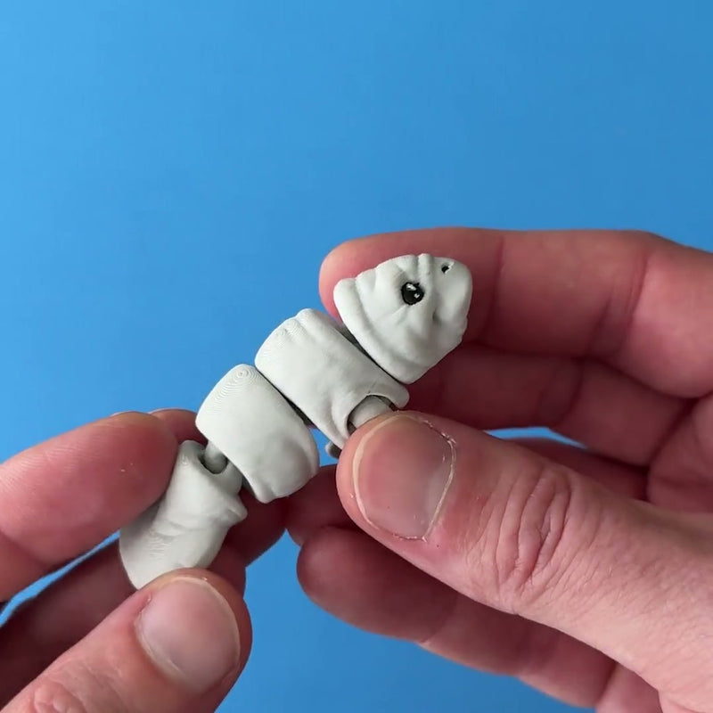 Snoots the Manatee 3D printed fidget wiggling in hand