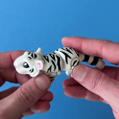 Snowpaws the White Bengal Tiger 3D printed fidget wiggling in hand