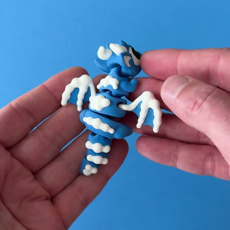 SnowPuff Dragon 3D printed fidget wiggling in hand