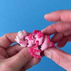 SnowPuff Dragon 3D printed fidget wiggling in hand