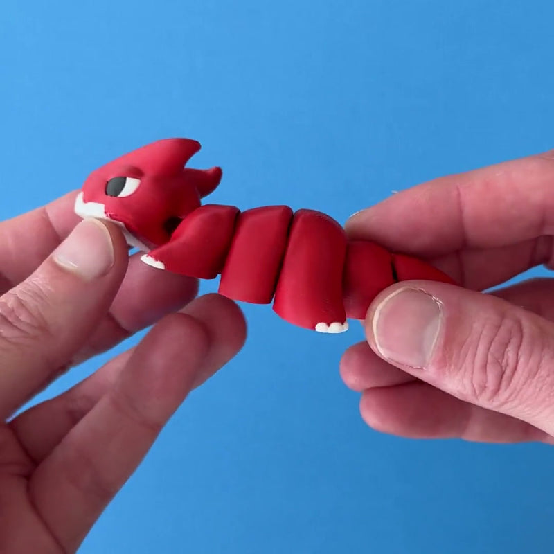 Snub the Chonk Dragon 3D printed fidget wiggling in hand