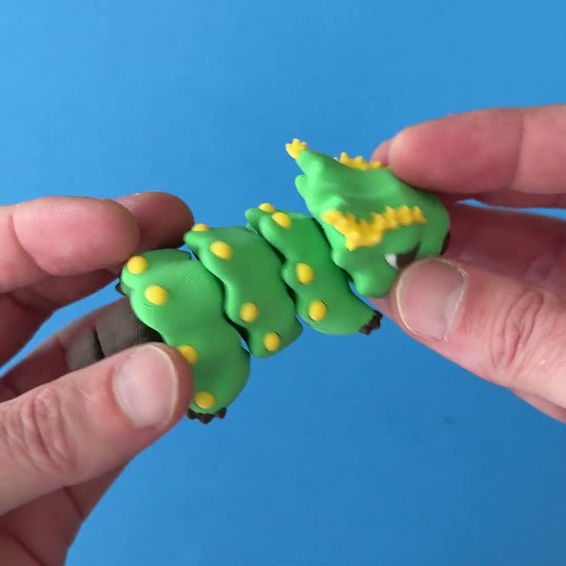 Twiggly the Xmas Tree Chonk Dragon 3D printed fidget wiggling in hand