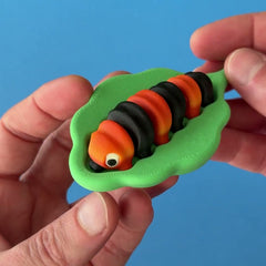 Ziggy the Caterpillar 3D printed fidget wiggling in hand