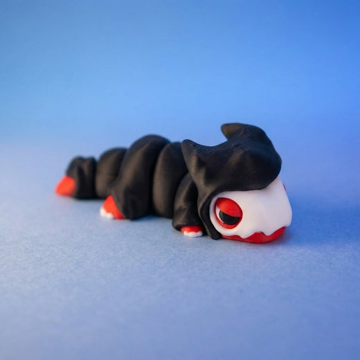 Black reaper dragon fidget toy seen from a different angle, showing its white fangs