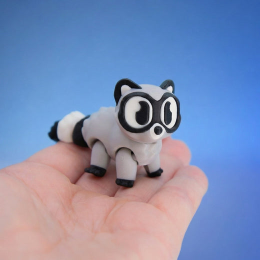 Close-up of the raccoon figurine's face and big eyes, standing on four legs
