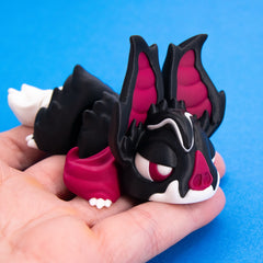 Sipp held in a palm showing his cape and ears, right view
