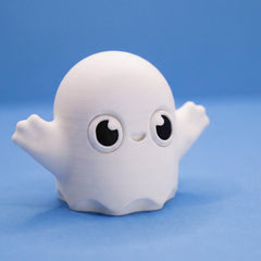 Close-up of the white ghost bean fidget's grinning face