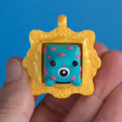 Spotto the monster in gold frame keycap clicker front view.