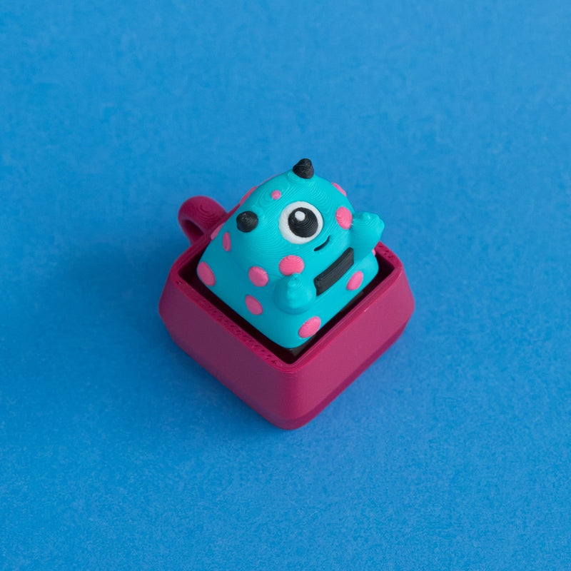 Spotto the monster keycap on plum clicker base.