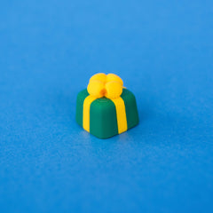 Sprig the green present keycap with a yellow bow
