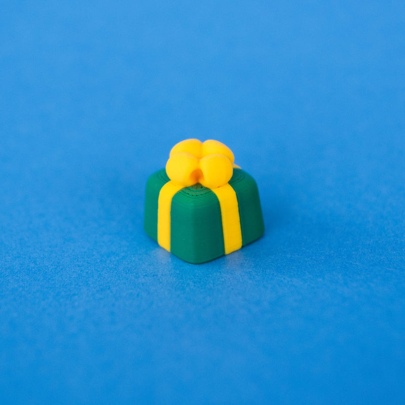 Sprig the green present keycap with a yellow bow