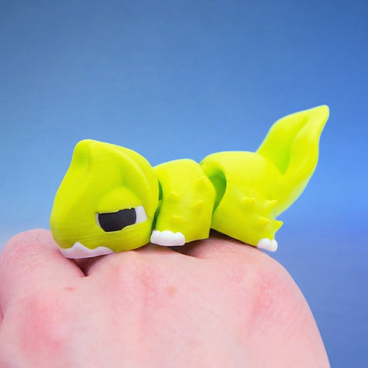 Close-up of the yellow-green chonk dragon fidget toy's face
