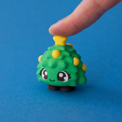 Tannen the Christmas Tree Clicker pressed on a blue background