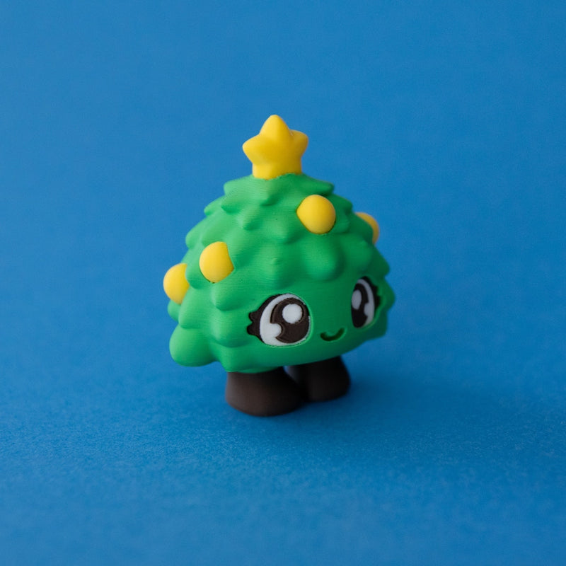 Tannen the Christmas Tree Clicker three quarter view on a blue background