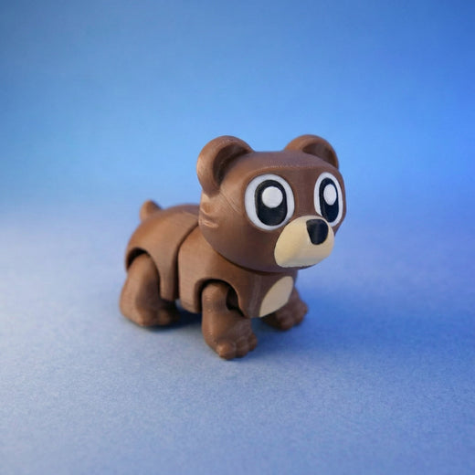 Brown bear cub figurine standing on four legs, front view